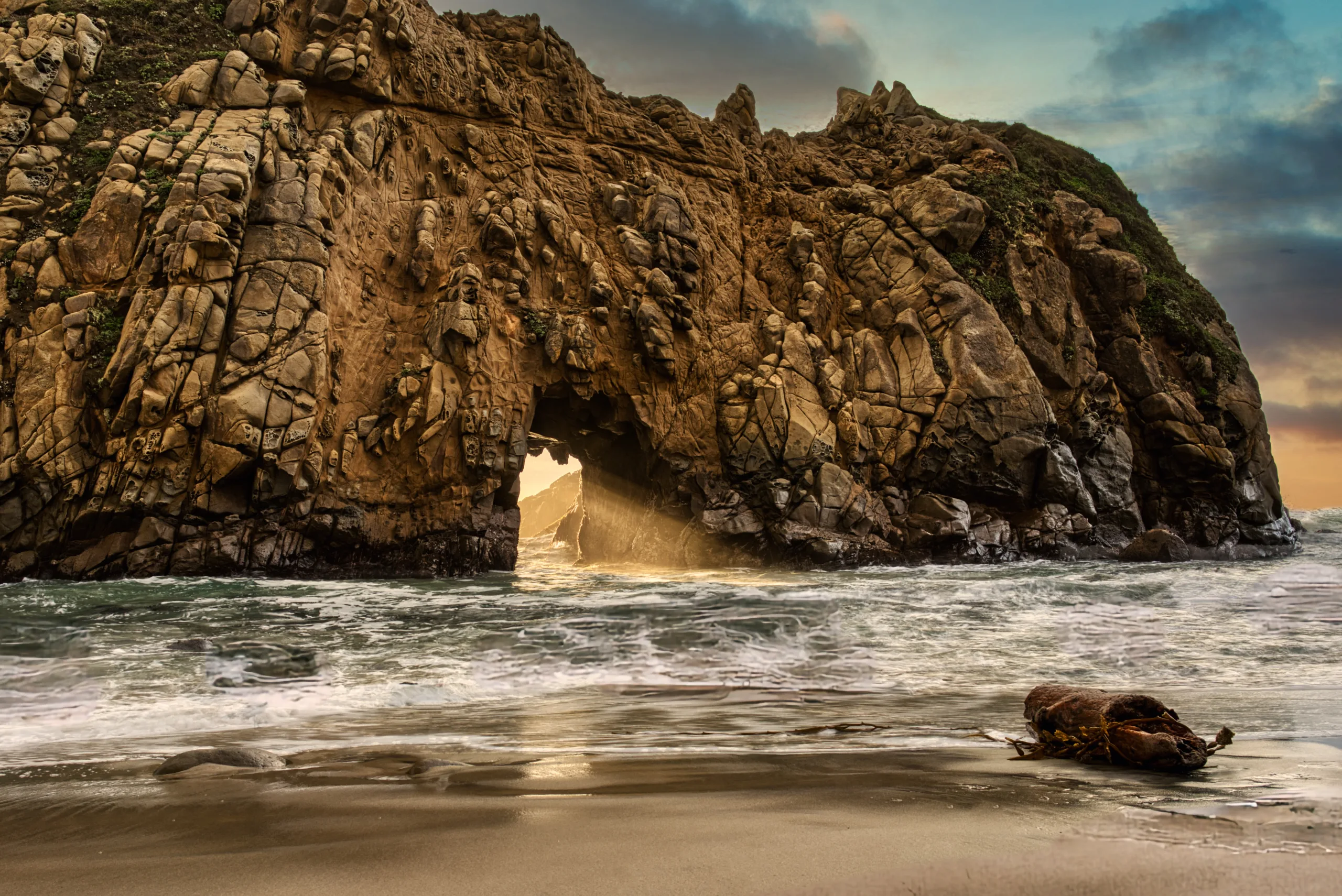 Brilliant sunset through the keyhole archway at Pfeiffer Beach.